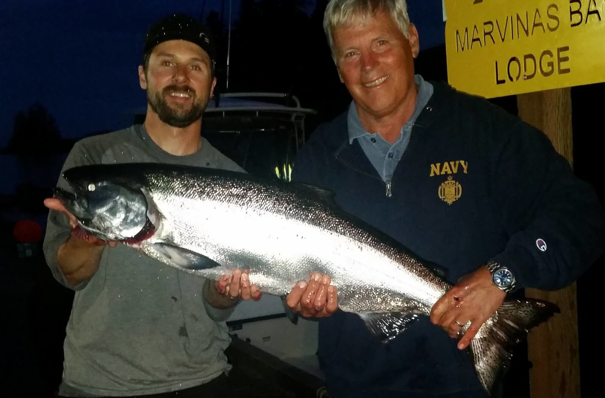 Two men holding Chinook Salmon caught on Fishing Charter