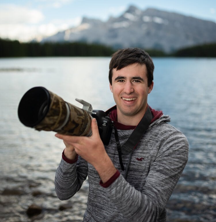 a man holding a camera up to take a picture