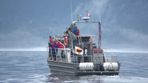 Whale watching boat filled with people on tour.
