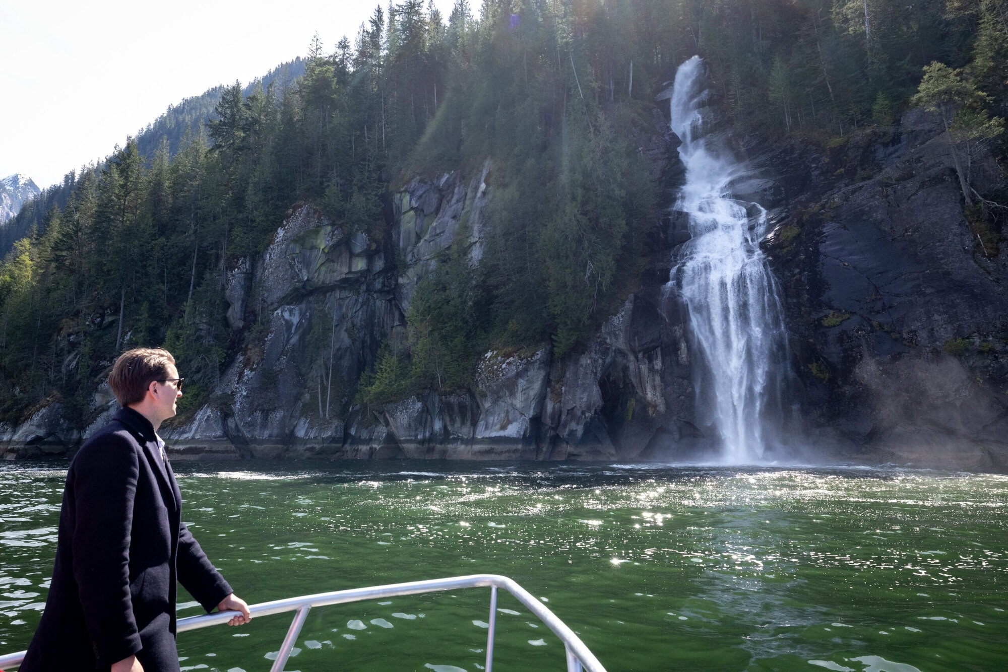 Guest looking at a waterfall in Toba Inlet