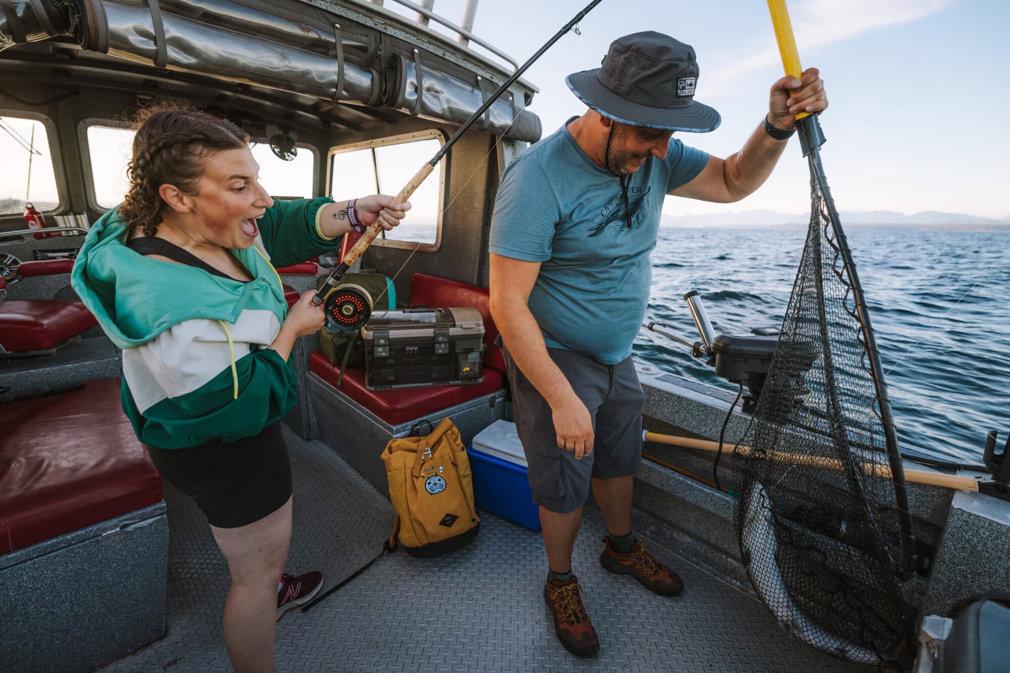 Two guests catching a salmon