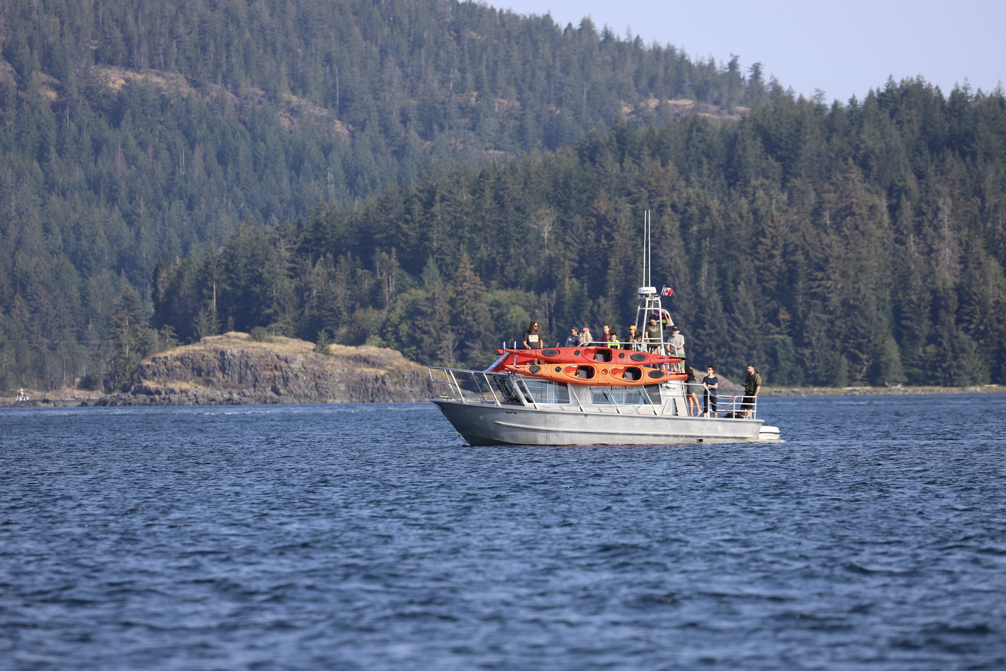 Covered boat loaded with kayaks