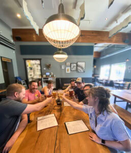 a group of people at a table in the brewery